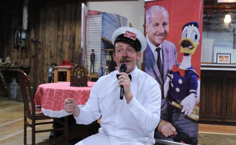 Nick Waters with American Storytellers, LLC, tells the story of Clarence "Ducky" Nash, the voice of Donald Duck for 50 years, on June 8 at the McLoud Museum and Historical Society. Presented by the McLoud Public Library, Waters told how Nash was born in Watonga, OK, where he imitated the animals on their farm as a child, including a baby goat which he voiced. His family moved to Mt. Washington, MO, when he was 10, and at 15, he performed in a talent show. Nash became a milkman before working for Disney.