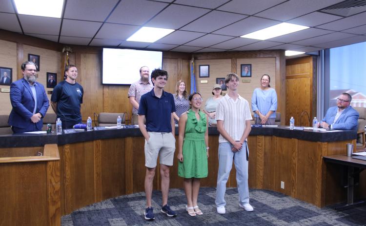 National Merit Scholars semifinalists Cooper Dunn, Kimberly Albers and Anthony Newsom pose with the Shawnee Board of Education during the Sept. 14 meeting. The Board, from left, are Clif Harden, Casey White, Turner Bass, Jeanne Swinney, Mandy Hillhouse and Kristen Wilson, with Superintendent Dr. Jason James, far right. (Board member Russ Oliver was not present.) Photos by Natasha Dunagan, Countywide & Sun