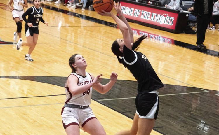 Tecumseh senior Kenzli Warden shoots from under the basket during the Class 4A Regional game against Tuttle, at Crossings Christian on Feb. 25. The Lady Savages lost to Tuttle, 19-40, but in their first Regional game, Feb. 23, they won with Broken Bow, 59-26. They advance to Area play today (March 2) in Henryetta. Photo provided by Kenetta Lisenbee.