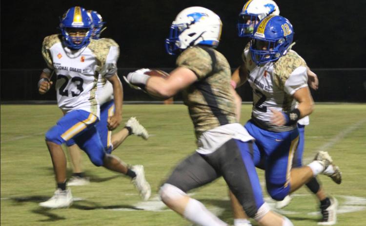 Bethel junior John Allred sprints with the ball as two Holdenville players look to tackle him during the district home game on Military Night, Oct. 14. Bethel won 67-13. Countywide &amp; Sun/Natasha Dunagan