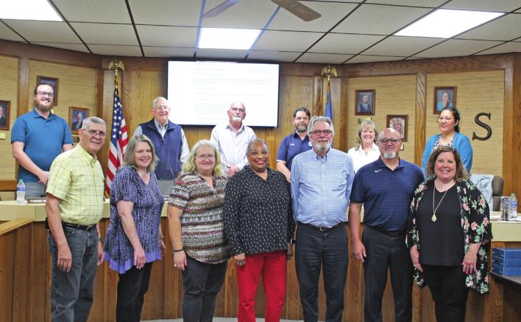 The Shawnee Board of Education honored those school employees who are retiring this year at their May 2 meeting. Shown, front row from left, are John Stell, Pam Hodges, Sharon Ferguson, Brenda Webb, Steve Maple, Todd Boyer and Kristi Heilaman. The board members in the back row are Turner Bass, Larry Walker, Keith Sandlin, Clif Harden, April Stobbe, and Kristen Wilson. Those retirees not pictured are Donna Hibler, Patricia Koehler, Pamela Sparks, Vera Elrod, Norma Neely, Beverly Permetter and Pam Woods.