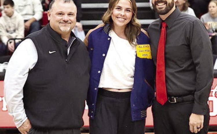 North Rock Creek's Sophie Morris receives her fast pitch all state jacket from coaches Josh Ray and Mike Cox. Photo Provided by Gowin Photography