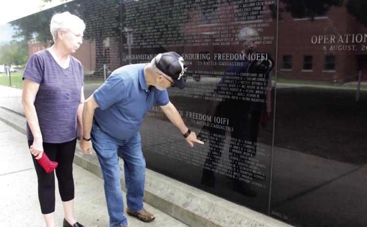 Linda and David Hendrickson point out where their son's name is on the Oklahoma Veterans Memorial Wall at Woodland Veterans Park in Shawnee during the Fifth Annual Gold Star Families Memorial Ride on May 24. Their son, Robert T. Hendrickson, was the last one killed in his unit during Operation Iraqi Freedom on Feb. 1, 20 years ago. Natasha Dunagan, Countywide & Sun