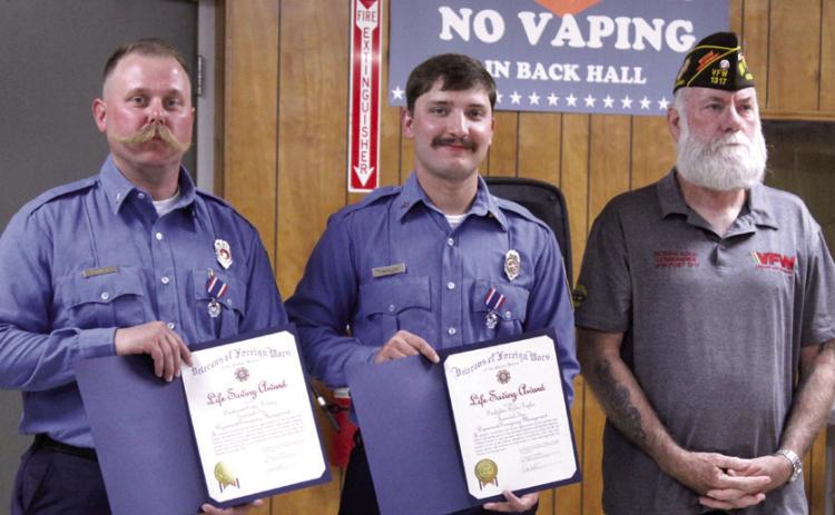 Tecumseh firefighters Lt. Eddie Kidney and Dylan Taylor received VFW Life Saving Award medals and certifi cates from Post 1317 Commander Patrick Koch (right). After responding to a vehicle swept away by fl ood waters, they deployed a rescue boat and saved one victim. 'These two fi refi ghters embody the very essence we all strive for with professionalism, and I'm truly proud to recommend them both to the VFW First Responders Recognition Program,' said Koch. Natasha Dunagan, Countywide & Sun