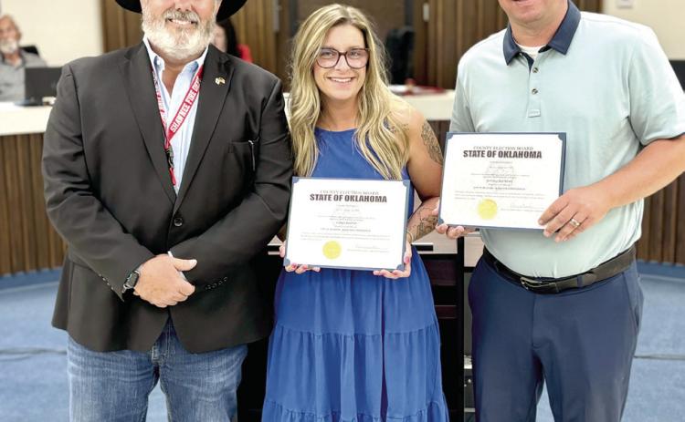 Shawnee Mayor Eric Stephens poses with re-elected commissioners, Lauren Richter (Ward One) and Daniel Matthews (Ward Six) after their swear-in at the July 20 City Council Meeting. Photo provided.