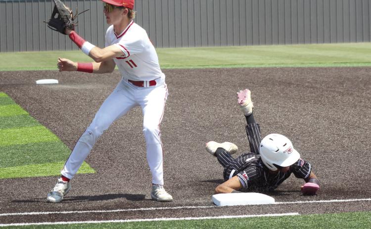 Dale junior Chase Harris waits for the catch, as a Kansas runner dives back to first, in the fourth inning of the Class 2A1 State Baseball Quarterfinal game, held at Shawnee High School on May 14.