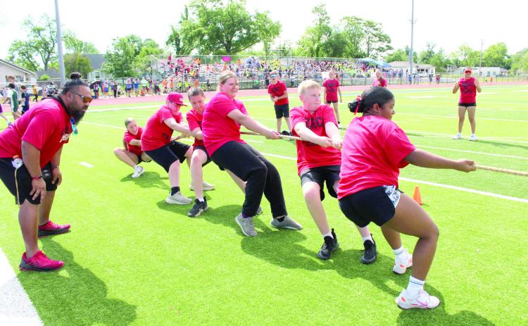 North Rock Creek football and Special Olympics coach Joe Schwabe cheers on his tug-o-war team as they pull against South Rock Creek in the Kiwanis Little Olympics championship on May 5 at Jim Thorpe Stadium. Natasha Dunagan, Countywide & Sun