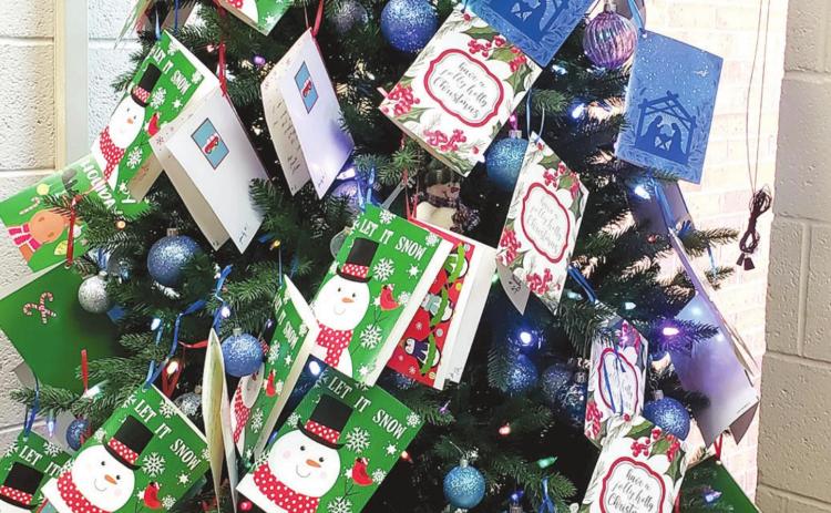 The Bows of Love tree filled with lists for local children was in the lobby of the Tecumseh Police Department last year. This year’s tree should have the lists ready Monday, Nov. 29, for those who would like to participate in 2021. File photo