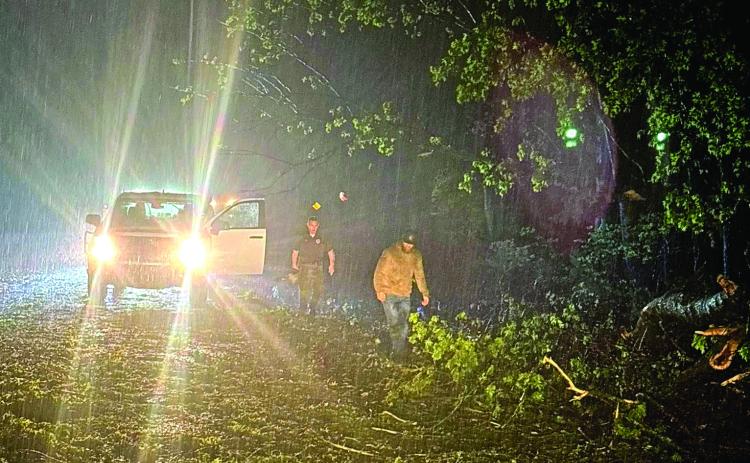 Emergency Management Director Aaron Scott (right) and Sheriff Freeland Wood begin clearing roads immediately following the storms April 3. Photo provided by Pott. County Emergency Management