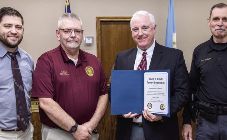 McLoud Police Department received its accreditation certificate. Pictured from left are McLoud Mayor Daniel McClure, Tuttle Police Cheif Don Cluck, McLoud Police Cheif Kyle Webb and McLoud Police SGT. Michael O'Leary. Photo courtesy of Monica Poindexter
