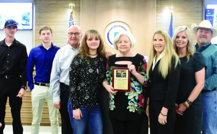 County commissioners from right, Greg Rush, Abby Thompson, and Melissa Dennis presented a plaque to the family of David Hammer. From left Garrett and Connor Hammer, Ronny Jones, Samantha Hammer and Ann Jones. The Pottawatomie Bar Association is having a plaque made to be placed at a tree in the courtyard of the Administration Building in honor of David Hammer. Countywide &amp; Sun/Suzie Campbell