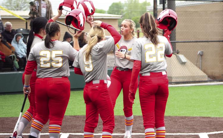 Dale senior Chayse Caram hits helmets with her teammates after hitting a homerun in the third inning of the game with Wayne on April 27. Dale won that game, 18-12, as well as the game with Boone-Apache, 17-4, to win the Class 3A Regional Slow Pitch Tournament at FireLake Ball Fields. The Lady Pirates began State play Wednesday. Watch next week’s Countywide &amp; Sun for story and photos. Countywide &amp; Sun/Natasha Dunagan