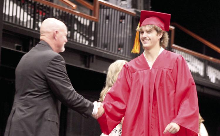 Maddox Caldwell shakes hands with Dale Board of Education Clerk Ronnie Newton during the Dale High School graduation at FireLake Arena on May 22. DHS graduated 46 seniors this year. Natasha Dunagan, Countywide &amp; Sun