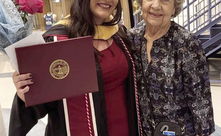 Kayxandra (KC) Campbell (left) celebrates earning her master’s degree in social work with her Granny, Joyce Stiles. Campbell took the helm as executive director of the Child Advocacy Center of Central Oklahoma (CACCO) just months before graduating. Photo provided