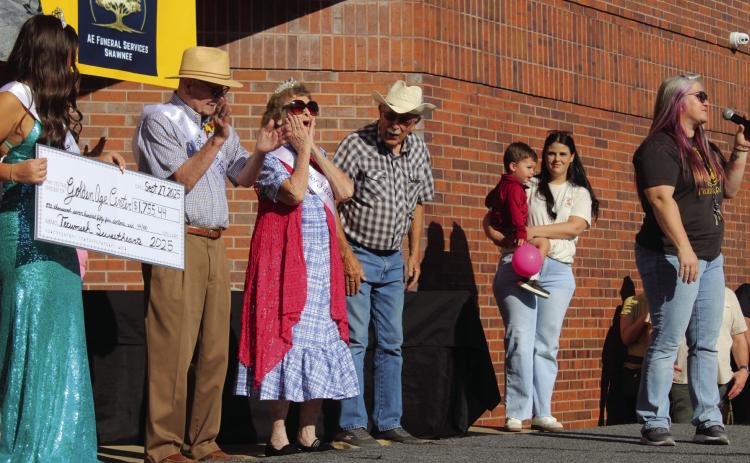 Senior Sweetheart Almeda Dyer gasps and Tecumseh Frontiersman Lonnie Hurst, left, claps as 2024 Miss Frontier Days Jalee Meyers presents a check for $1,755.44 to the Golden Age Center before the Frontier Days Parade on Sept. 27. Also shown are Jack Parson, President of the GAC Site Council, Pageant Director Katie McMahan and Tecumseh Chamber of Commerce Executive Director Kimberly Elliott, far right. Natasha Dunagan, Countywide &amp; Sun