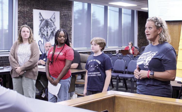 Jefferson Elementary Principal Jennifer Epperley speaks with the Shawnee Board of Education during the Oct. 5 meeting, as Instructional Coach Katelyn Miears , Nedra Edwards and Isaiah Peters look on. They led the flag salutes and invocation and also led the Board in a math-based game of 'I'm Thinking of a Number.' Natasha Dunagan, Countywide &amp; Sun