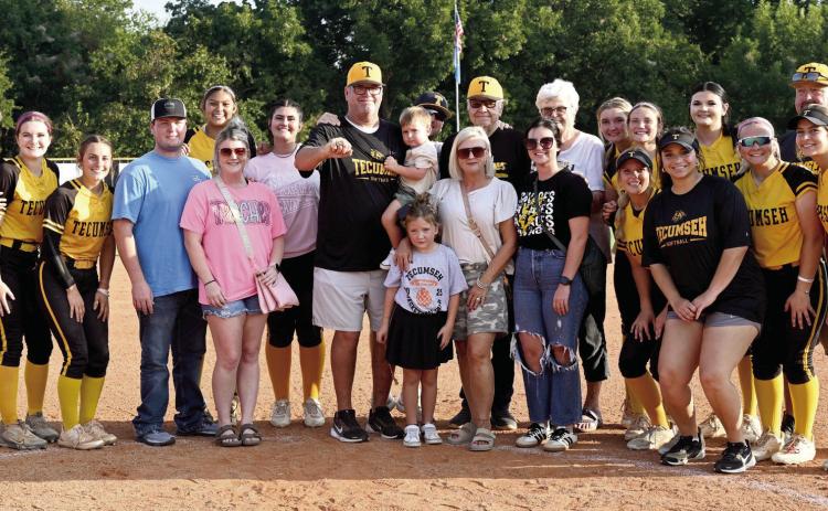 Tecumseh Fast Pitch Head Coach Chad Trahan poses with his team and his family, as he shows his Oklahoma High School Fastpitch Softball Coaches Hall of Fame ring at the home game with Berryhill on Sept. 16. Trahan was inducted into the Hall of Fame in June. He also received a game ball for winning 500 games that day. Photo courtesy of Kenetta Lisenbee