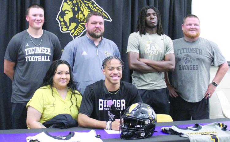 Tecumseh senior Marquan Krush signed a letter of intent to play football with Southwest College in Winfield, KS on March 14. Head Football Coach Ty Bullock and THS Principal Randy Dilbeck spoke at the event about Krush’s faith, integrity, unselfishness and work ethic. Shown, seated, is his mother Stacia Thompson and Krush, back row second from left, Bullock, with assistant coaches, Indy McNutt, far left; Josiah Wright and Easton Marrs. Countywide &amp; Sun/Natasha Dunagan
