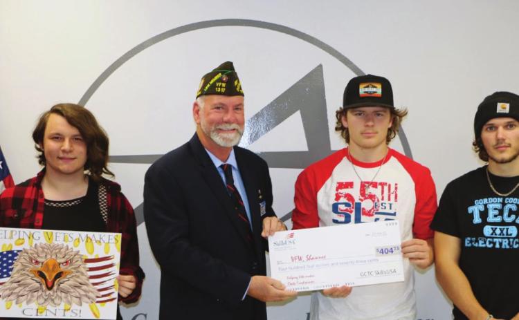 SkillsUSA students at Gordon Cooper Technology Center collected 8,615 pennies and raised $404.73 to help local veterans with their “Helping Vets Makes Cents” coin drive. Pictured from left are Graphic Design student Sheldin Mills, Shawnee HS, holding the design created by Alexandria Flatt, Bethel HS; Patrick Koch, VFW Post 1317/Jr. Vice Commander, Shawnee; Kaden Johnson, Electrical Trades and Meeker HS; Brett Mingo, Electrical Trades and Meeker HS.
