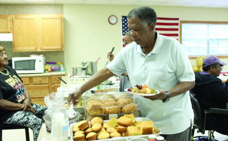 Bobby Jackson, who was originally from Brooksville and now lives in Midwest City, serves himself during the Brooksville 122nd Anniversary Celebration, held at the Brooksville Community Center on Oct. 18. Brooksville is one of the remaining 13 all-black towns in Oklahoma, out of an original 50-plus, according to the Oklahoma Historical Society website. It was originally named Sewell, but was renamed in 1912 after A.R. Brooks, a cotton buyer and farmer. Full cutline below. Natasha Dunagan, Countywide & Sun