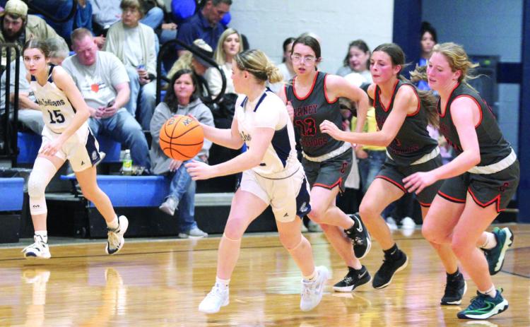 After stealing the ball, Asher’s Makaylee Herrell is followed by three Carney defenders on the way to the hoop at the end of the fourth quarter of the Nov. 22 home game. The Lady Indians won, 42-11. Countywide & Sun/Natasha Dunagan