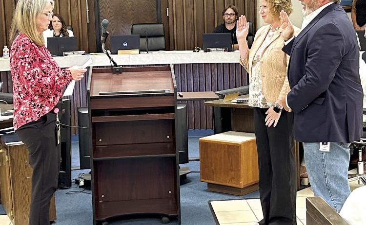 Shawnee City Clerk Lisa Lasyone (left), swears in the new Ward 2 City Commissioner Greta Madson, and new Mayor Eric Stephens. With the recent change to the charter, newly elected officials take office the first meeting after winning an election. Both were also presented with their Certificate of Election. Photo provided by the City of Shawnee