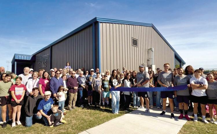 Community members, fans, athletes, and staff gathered together to celebrate and cut the ribbon of Paul Duffield Tennis Complexon April 17. Photo provided by SPS