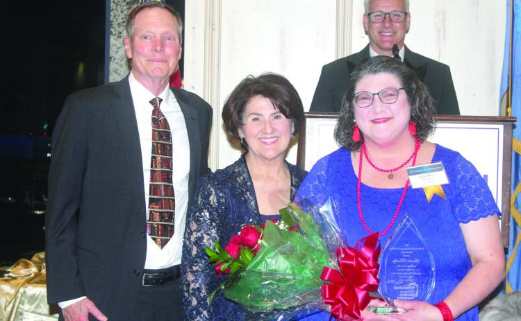 Shawnee teacher Sandra Bradley, far right, poses with Mike and Ginger Tinney after accepting the 2024 Jonathan Tinney Special Educaton Educator Merit Award at the Professional Oklahoma Educators Foundation awards ceremony in April. The award is named in memory of the Tinneys’ infant son who was born with Down’s Syndrome in 1989. Photo provided.