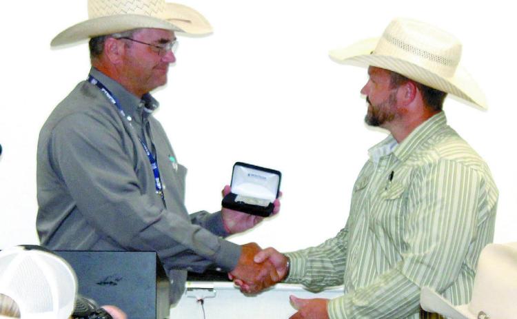 IPRA/IFYR General Manager Dale Yerigan presents a Montana Silversmith credit card holder to Dr. Alex Simpson who has served as the veterinarian on-call at the IFYR for 10 years. Natasha Dunagan, Countywide & Sun