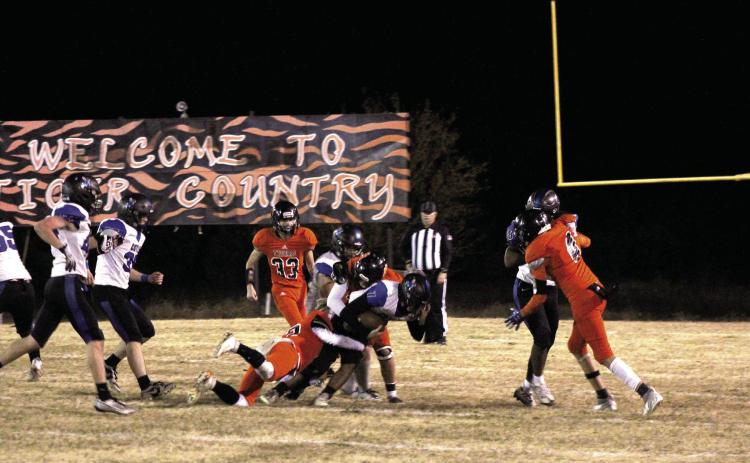 A few Maud defensive players take down a Coyle ball-carrier in the second quarter of the Class C OSSAA First-Round Playoffs on Nov. 10. The Tigers lost a hard-fought home game to the Coyle Blue Jackets, 14-60. They end the season with a record of 7-4. Countywide & Sun/ Natasha Dunagan