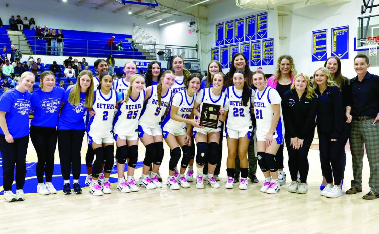 The Bethel Lady Wildcats and their coaches pose with the Class 3A District Basketball Championship trophy after beating Lexington on Feb. 20. They advanced to the Regional Tournament on Feb. 24 in Jones. Photo courtesy of Richelle Treece
