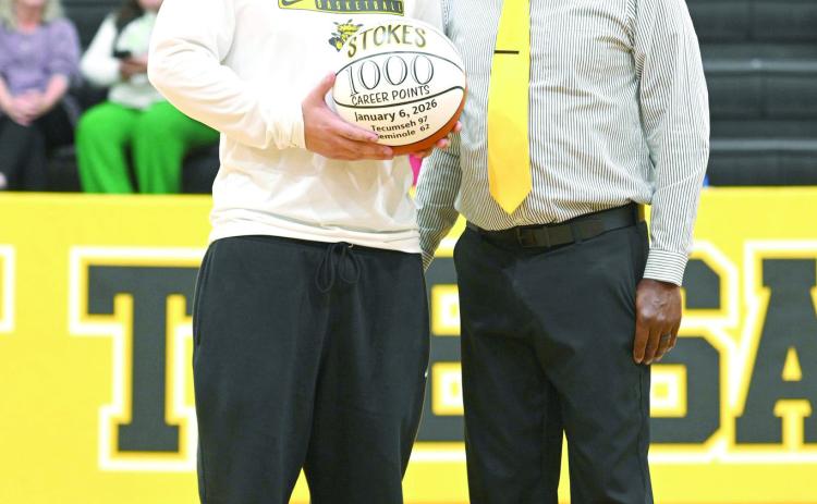 Tecumseh senior Aveon Stokes receives a game ball from Head Coach Bryant Edwards at halftime of the Lady Savages home game on Jan. 13. The ball was in honor of Stokes reaching 1,000 career points during the home game against Seminole on Jan. 6. Photo courtesy of Kenetta Lisenbee