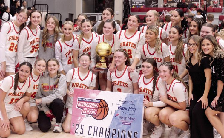 The Dale Lady Pirates pose with their trophy after winning the Dale Boomarang Basketball Classic on Dec. 13. Over the three-day tournament, they won all three games: Mustang JV, 77-32; Alva/Freedom, 53-44; and, Washington, 75-69. Their head coach is Eric Smith. Photos by Natasha Dunagan, Countywide &amp; Sun