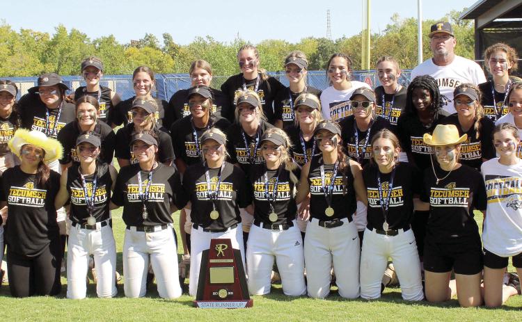 The Tecumseh Lady Savages Fastpitch Team and their coaches, Perry Wilson and Chad Trahan, pose with the Class 4A State Runner-Up Trophy following their game against Lone Grove on Oct. 15. The Lady Savages lost in the Finals, 0-3, after winning in extra innings during both the Quarterfinals with Cache, 2-1, and the Semifinals with Miami, 3-0. They end the season with a record of 29-13.