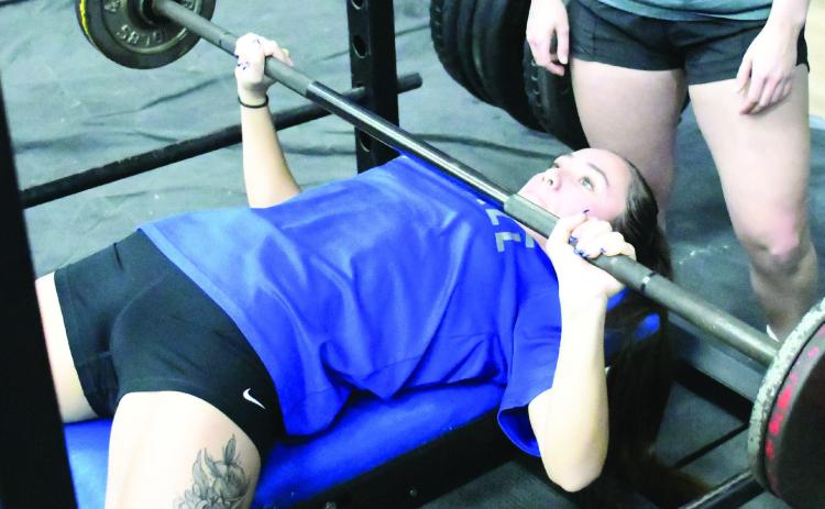 Bethel's Stohri Rhynalds bench presses during the Chandler Powerlifting Meet, held on Feb. 10 and 11. Rhynalds placed first in her weight division. Photo courtesy of Brian Blansett, Lincoln County News