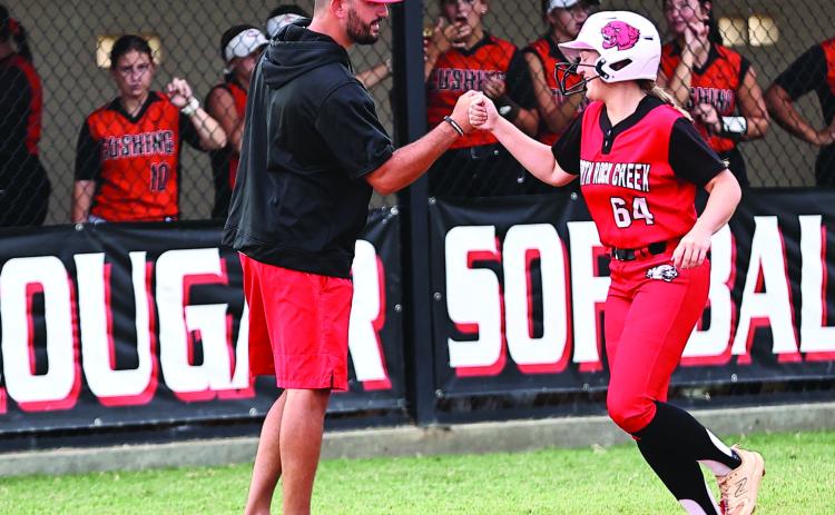 Pictured right, North Rock Creek’s Ashlyn Bade celebrates with Coach Griffin after she hits a homerun. Photo courtesy of Gowin Photography