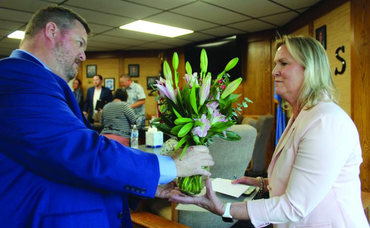 New Shawnee Superintendent Dr. Jason James presents flowers to Interim Superintendent Dr. Teresa Wilkerson following the May 5 Board of Education meeting. James said they were "mistakenly delivered to his office." Wilkerson is retiring this year. Natasha Dunagan, Countywide & Sun