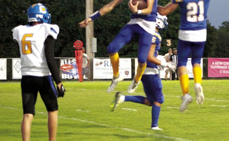 Bethel juniors Reagan Curry (#10) and R.J. Morris (#21) jump in celebration of Curry receiving the ball in the end zone for a touchdown during the season opening home game on Sept. 2. Bethel won 43-12. Countywide & Sun/Natasha Dunagan