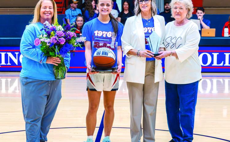 Seminole State College Women’s Basketball Head Coach Rita Story-Schell was honored during the Belles’ home game Monday, Feb. 16, after earning her 450th career win with a Feb. 12 victory over Western Oklahoma State College in Altus. Pictured (left to right): Athletic Director Leslie Sewell, sophomore forward Alona Cooper-Rochovitz, Story-Schell and SSC President Lana Reynolds. Photo Provided