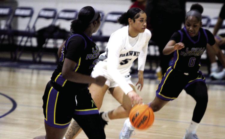 Shawnee junior Chrishelle Milum guards the ball on her way to the hoop during the Jan. 6 home game against Will Rogers. The Lady Wolves won 46-26, and the Wolves followed suit, 82-25. Natasha Dunagan, Countywide & Sun