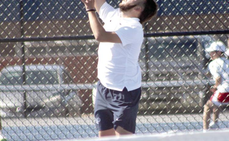 Shawnee junior Bryce Comstock, on #1 Doubles with junior Benji Cole, serves during the Shawnee NGB (National Governing Body) Tournament on May 3. They were playing against Tecumseh. Photos by Natasha Dunagan, Countywide & Sun