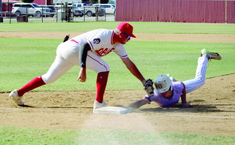 Dale senior A.J. Carpenter tries to tag an Okarche runner as he dives back to first base during the Dale Baseball Invitational Championship game on Aug. 16. Dale won their first two games - 4-1 with Preston on Aug. 14 and 6-3 with Calumet on Aug. 15 - and lost this final game, 1-6.