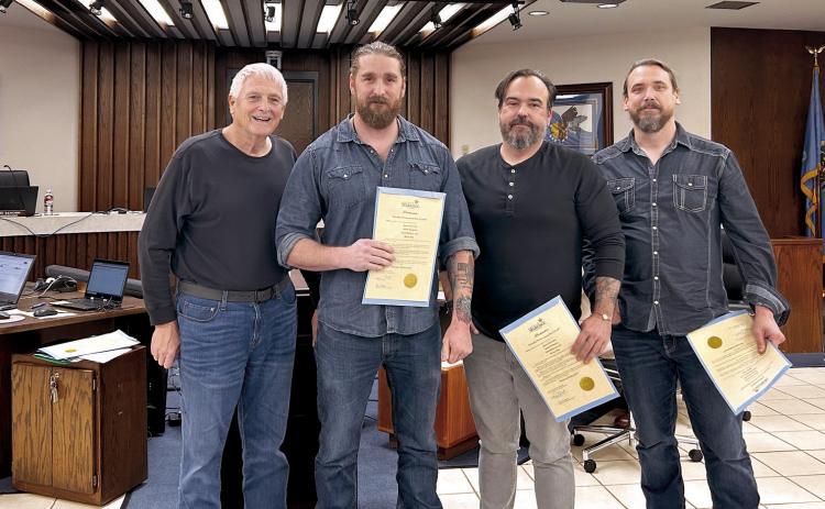 Mayor Ed Bolt (left) recognizes Outsider Productions and Play It Loud for their continued work in the film industry in the Shawnee area. Pictured from left are Bolt, Adam Hampton, Jason Alexander and Kenny Pitts. The fourth member of the group, Chad Mathews was unable to attend the meeting. Countywide &amp; Sun/Suzie Campbell