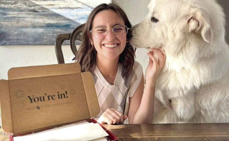 Shawnee graduate Chiara Carpenter celebrates her acceptance into the University of Oklahoma with support from her dog. Carpenter was in the Shawnee High School Class of 2023 that started high school during the COVID-19 pandemic and ended it with tornado damage to SHS. Photo provided.