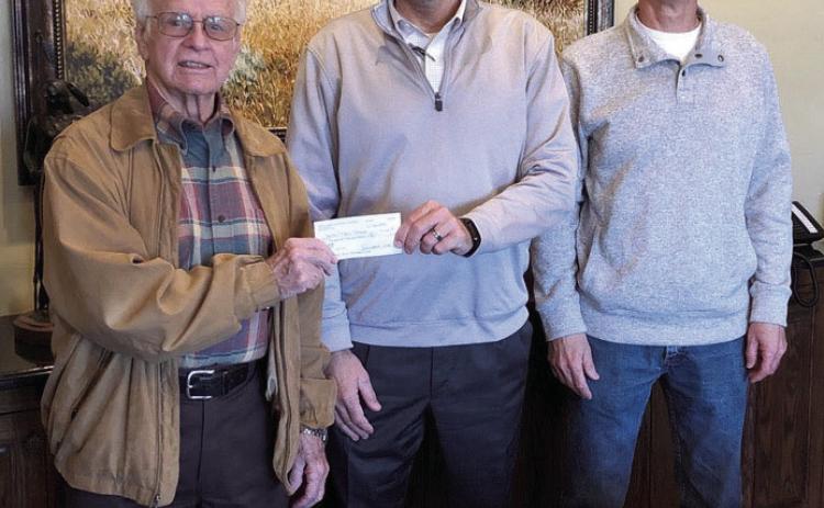 Bethel Superintendent Matt Posey accepts a $6,500 check from Pottawatomie County Facilities Authority Chairman Leonard Taron, left, and Vice-Chair Tom Wilsie at West Law Firm in Shawnee. Bethel Public Schools plans to use the money for signage on their campuses, including their new Upper Elementary. Photo provided.
