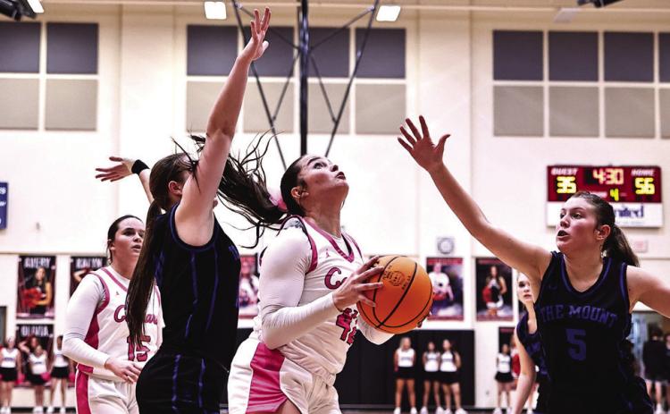 Tuesday, Jan. 30 was North Rock Creek’s pink out night against Mount St. Mary. Sarah Campbell goes between two defenders for the shot. Girls won 66-41.