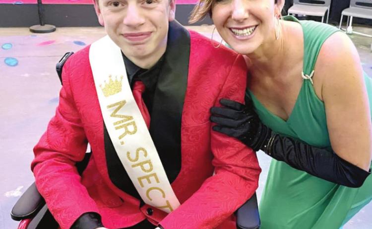 SCI Executive Director Tina Hanna congratulates Ian Brown who was crowned as Mr. Spectacular at the first pageant. Photo provided