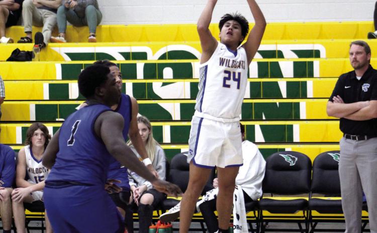 Bethel's Si Foreman tries for a three-pointer during the game against Mount St. Mary, Jan. 3 at OBU. The Wildcats won 74-64. The Lady Wildcats also won their game against MSM, 66-32. Countywide & Sun/Natasha Dunagan
