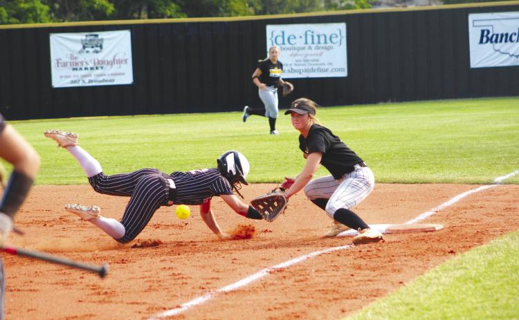 Tecumseh junior Jessi Hull guards first base and prepares for the catch as a Perkins-Tryon runner dives back to safety in the second inning of the home game on Aug. 7. Tecumseh won their first game of the fastpitch season, 15-1. Countywide &amp; Sun/Natasha Dunagan