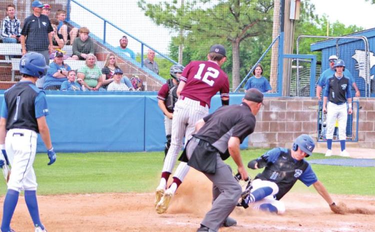 Bronc Robbins steals home with a slide.